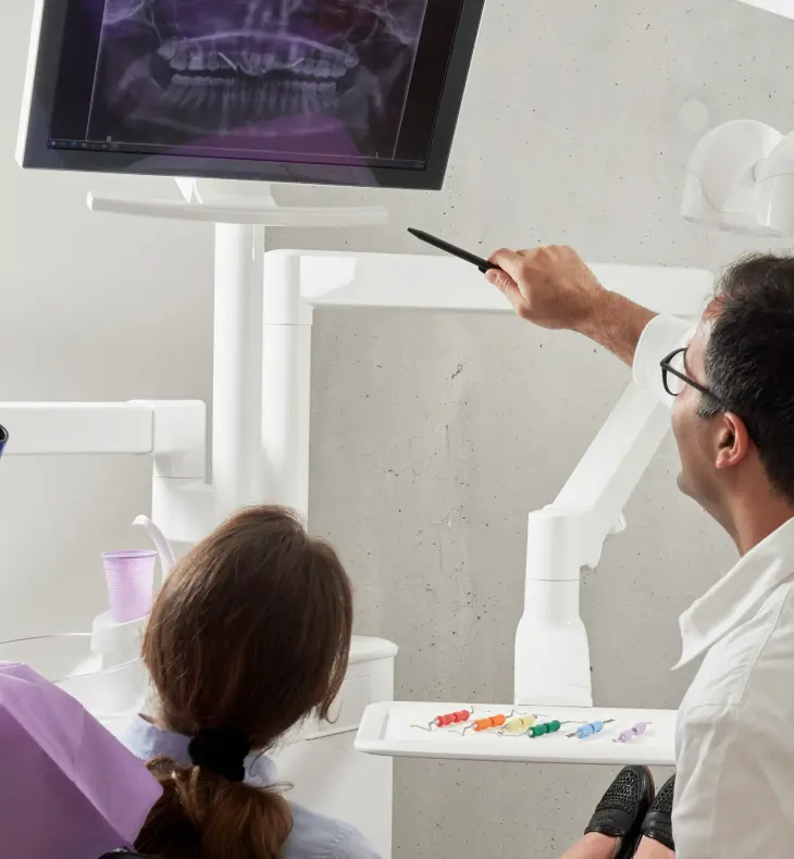 A dentist showing a dental X-ray to a patient