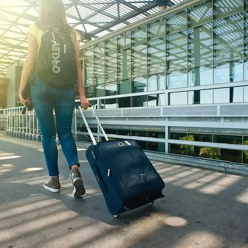 A traveller walking with a suitcase
