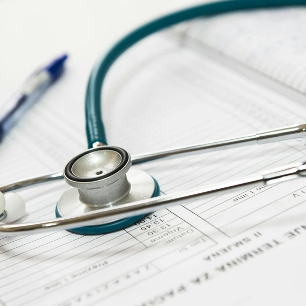 A stethoscope resting on medical documents